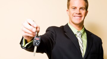 Smiling teenage girl holding keys inside car