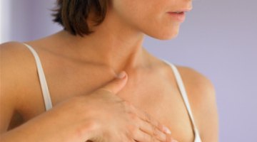 A woman feeling her swollen breast