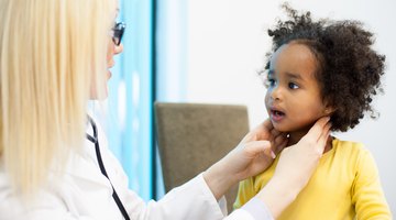friendly  children's doctor examining newborn