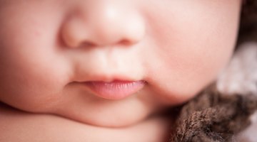 Sweet baby with blue eyes playing peek-a-boo