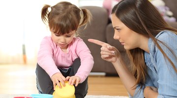 Young woman with cell phone and annoying children