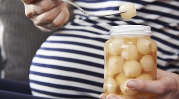 Pregnant woman eating vegetables