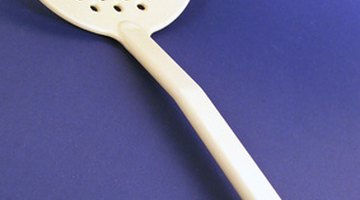 A plastic ladle made from melamine, a common material used for plates.