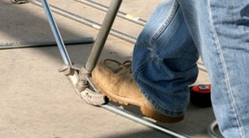 Here an electrician is bending a conduit pipe.