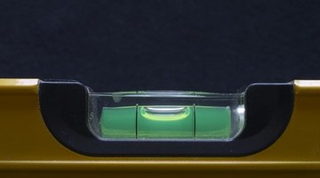 A magnetic level is used to set the door frame.