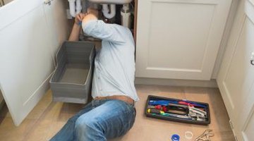 Man fixing sink pipe