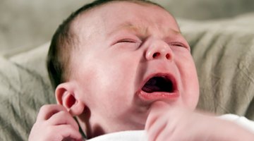a caucasian baby begins to cry loudly