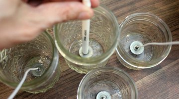 Place the wicks in the containers
