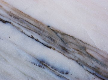 Marble has a smoother surface than quartzite.