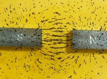 Iron filings trapped between two magnets.