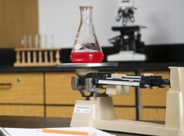 Use triple beam balances to measure the mass of liquid in a flask.
