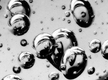 Mercury forms into shiny mirror-like beads because of its high surface tension.