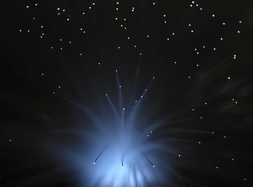 Shooting stars adorn a night landscape.