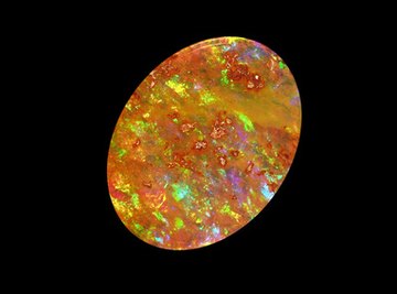 The sparkle in precious opals like this Mexican fire opal is caused by light bouncing off of crystalline silica structures.
