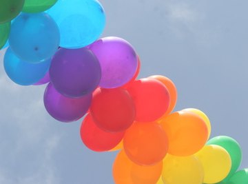 Fill colorful balloons with helium for party decorations.