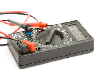 Test a resistor on a lawn blower using a digital multimeter.