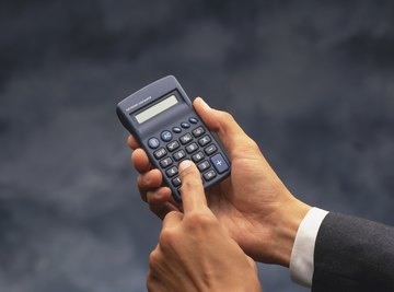 A man is holding a calculator.