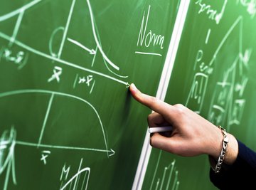 A scientist making calculations on a chalkboard.