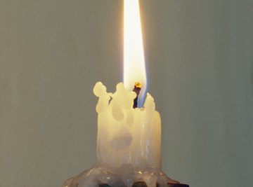 When a candle is placed underneath water, its heat is transferred to the water.
