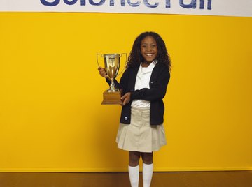 Student winning trophy at a science fair