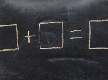 Close-up of equal sign equation on chalkboard.