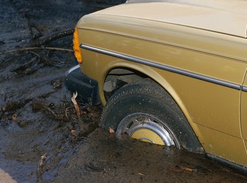 A car is stuck in the mud after a flood