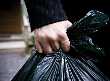 Black plastic garbage bags on the ground waiting for recycle