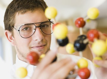 Student holding a molecular model