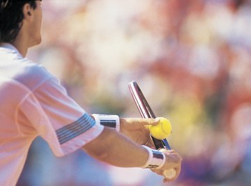 A man preparing to serve during a tennis match.