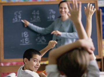 Young students raising hands in math class.