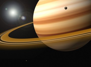 Saturn travels slowly in its orbit but spins quickly on its axis.