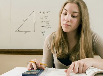 A student working with a calculator in a classroom.
