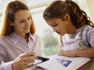 Teacher explaining to young student.