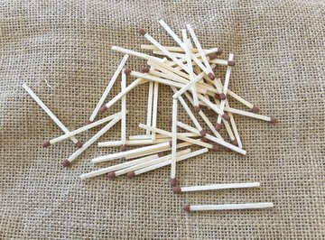 An overhead view of matchsticks on linen fabric.