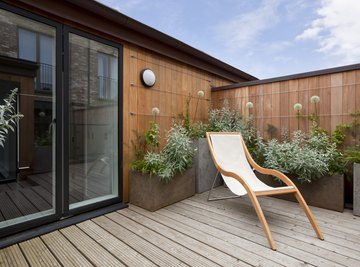 A sunning chair on an urban garden balcony.