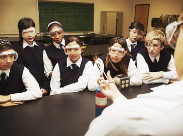 Students watching teacher in science lab.