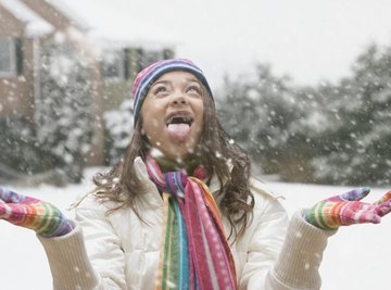 Young girl playing in the snow.