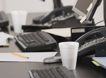 A styrofoam cup on an office desk.