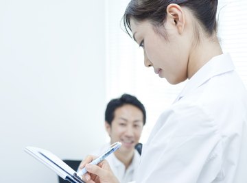 Scientist writing on a clipboard