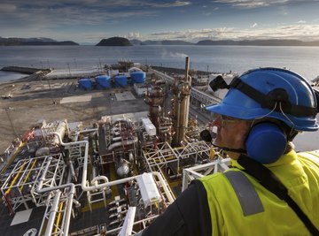 An employee looking over an oil drilling facility.