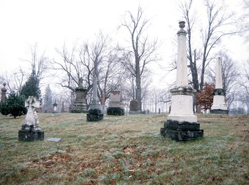 Acid rain reacts chemically with marble and limestone grave markers, pitting the stone and making details unclear.