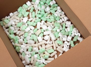 Opened cardboard box filled with polystyrene foam peanuts.