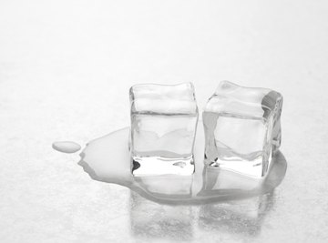 Ice cubes melting on table.
