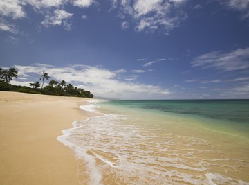 Beach sand is created by weathering and eroded by wind and waves.