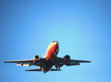 An airplane flying in a clear blue sky.