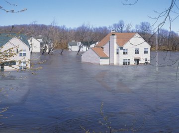 Floodwaters cause damage to homes.