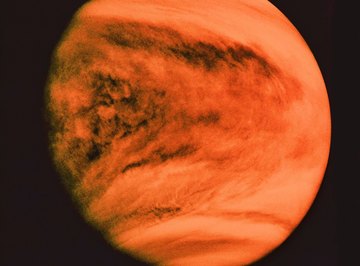 Venus appears in the night sky as a bright sphere close to the horizon.