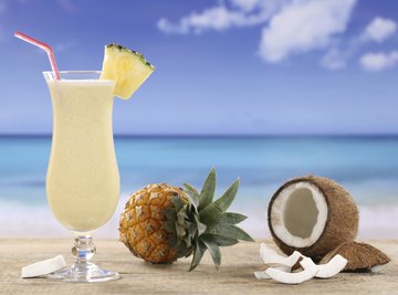 Coconut oil can dissolve in an aqueous pina colada because of the amphipathic nature of rum