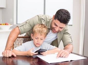 Image of father and son doing a math problem.