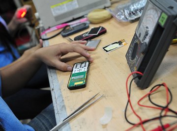 Students working on an electronics project at a table.